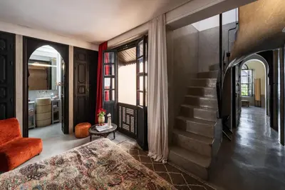 a living room with a bed and a staircase at Riad 72 in Marrakech