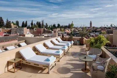 a row of lounge chairs on the roof of a building at Riad 72 in Marrakech