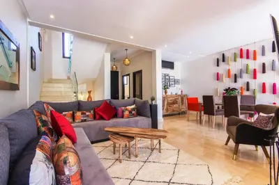 a living room with a couch and a table at VILLA Waky & Golf - Jardin de l'Atlas in Marrakech