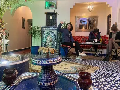 a group of people sitting in a lobby at Riad Lalla Merieme in Marrakech