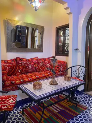 a living room with a couch and a table at Riad Lalla Merieme in Marrakech