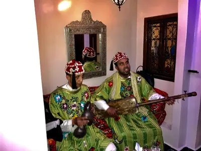 two people dressed in costumes sitting on a couch at Riad Lalla Merieme in Marrakech