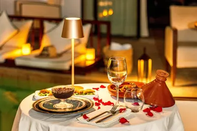 a table with a plate of food and wine glasses at Riad Luciano Hotel and Spa in Marrakech