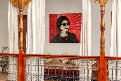 a painting of a woman with sunglasses on a wall at Riad Luciano Hotel and Spa in Marrakech