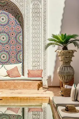 a room with a table with a potted plant at Riad Luciano Hotel and Spa in Marrakech