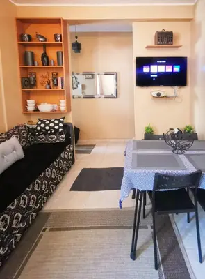 a living room with a table and a tv at Nice appartement à Marrakech in Marrakech