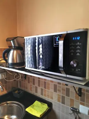 a microwave oven on a shelf in a kitchen at Nice appartement à Marrakech in Marrakech