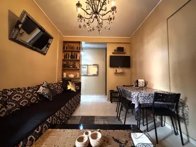 a living room with a couch and a table at Nice appartement à Marrakech in Marrakech