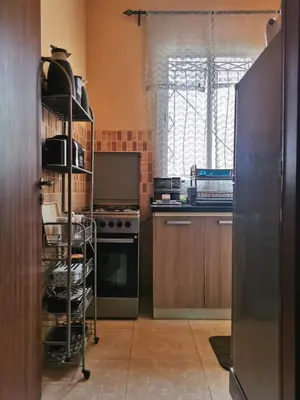 a kitchen with wooden cabinets and a stove top oven at Nice appartement à Marrakech in Marrakech