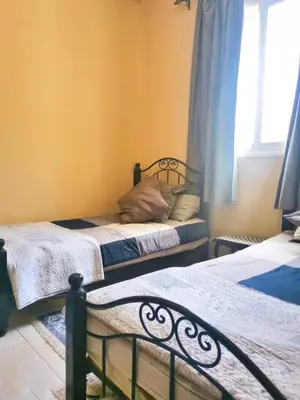 a bedroom with two beds and a window at Nice appartement à Marrakech in Marrakech