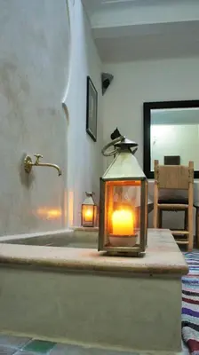 a lantern sitting on a table in a room at Riad Alqimam in Marrakech