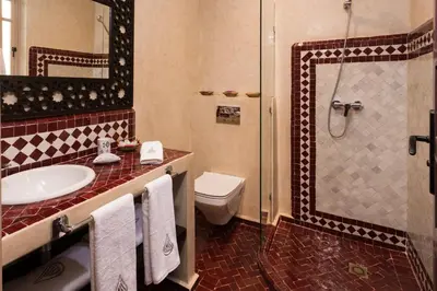 a bathroom with a toilet and a sink and a shower at RIAD AZRUR in Marrakech