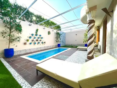 a swimming pool in the backyard of a house at Villa Paradis in Marrakech