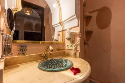 a bathroom with a sink and a mirror at Riad Medina Art & Suites in Marrakech