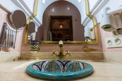 a sink in a bathroom with a mirror at Riad Medina Art & Suites in Marrakech