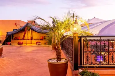 a patio with a fence and a potted plant at Riad Medina Art & Suites in Marrakech