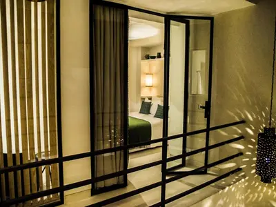 a view of a bedroom from a balcony with a mirror at Douiria13 in Marrakech