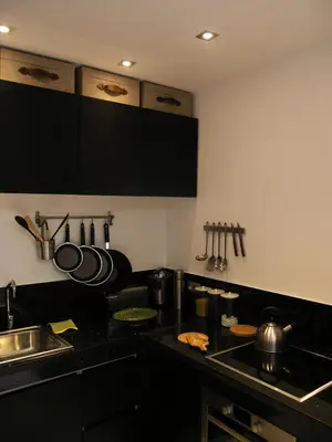 a kitchen with black cabinets and a counter top at Douiria13 in Marrakech