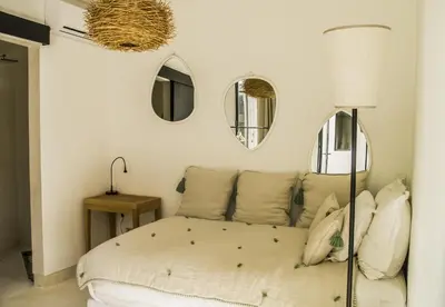 a bedroom with a bed with mirrors on the wall at Douiria13 in Marrakech