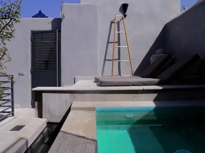 a swimming pool with a ladder next to a house at Douiria13 in Marrakech