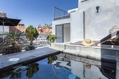 a house with a swimming pool with a hat on it at Douiria13 in Marrakech