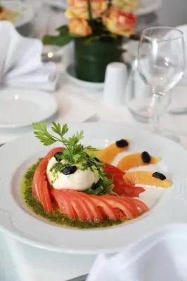 a white plate of food on a table at Kenzi Rose Garden in Marrakech