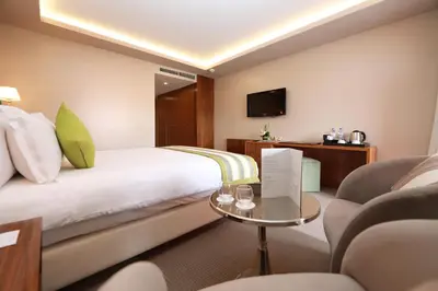 a hotel room with a bed and a table at Kenzi Rose Garden in Marrakech