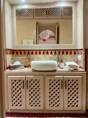 a bathroom with a sink and a mirror at Riad Zouhour in Marrakech
