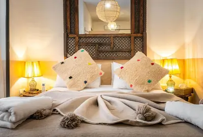 a bedroom with a bed with two pillows on it at Medina Sun in Marrakech
