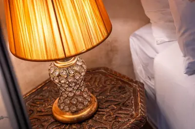 a lamp sitting on a table next to a bed at Medina Sun in Marrakech
