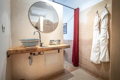 a bathroom with a sink and a mirror at Medina Sun in Marrakech
