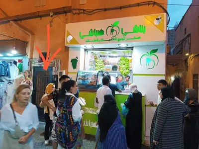 a group of people standing around a food truck at Terrace House in Marrakech