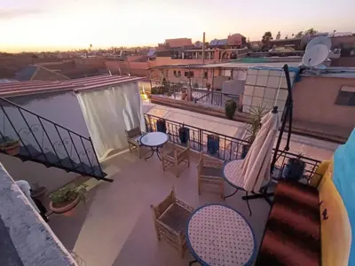 a balcony with tables and chairs on a building at Terrace House in Marrakech