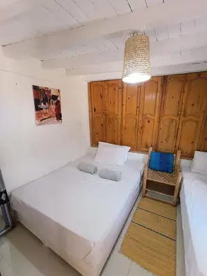 two beds in a room with wooden cabinets at Terrace House in Marrakech