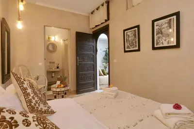 a bedroom with a bed and an open door at Riad Beata Bed & Breakfast in Marrakech