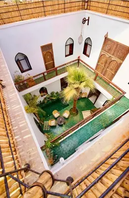 an overhead view of a house with a pool and palm trees at Riad Dar Yasaman in Marrakech