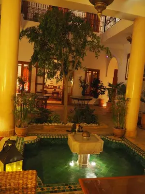 a pool in the middle of a building with a fountain at Riad Dar Kasal in Marrakech