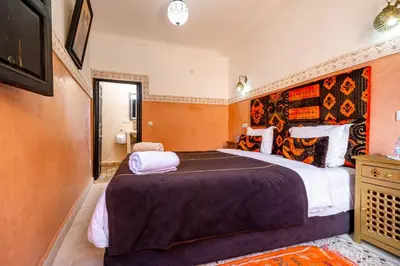 a bedroom with a large bed in a room at RIAD LA GAZELLE DU SUD in Marrakech