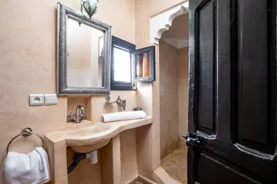 a bathroom with a sink and a mirror at RIAD LA GAZELLE DU SUD in Marrakech