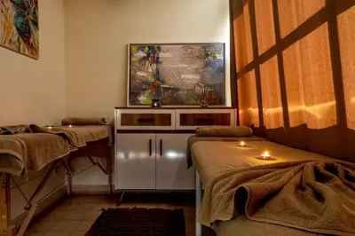 a room with two beds and a painting on the wall at RIAD LA GAZELLE DU SUD in Marrakech