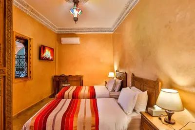 a hotel room with two beds and a lamp at RIAD VILLA SIDI BABA in Marrakech