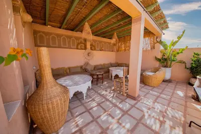 a patio with a couch and a table and a table at Riad 7 Saints in Marrakech