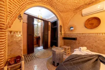 a bedroom with a bed and a shower in a room at Riad 7 Saints in Marrakech