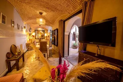 a living room with a flat screen tv on a wall at Riad 7 Saints in Marrakech