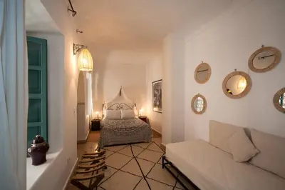 a living room with a bed and a couch at Riad La Clé de la Medina, location en exclusivité de tout le riad in Marrakech