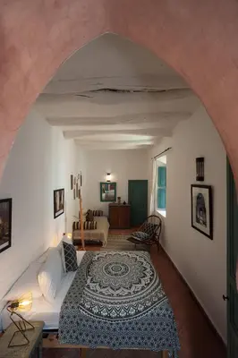 a bedroom with a bed and a living room at Riad La Clé de la Medina, location en exclusivité de tout le riad in Marrakech