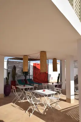a group of chairs and a table in a room at Miostello Lifestyle Riad Marrakech in Marrakech