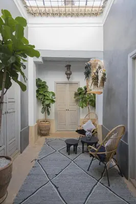 a living room with chairs and a rug at Riad Les Hirondelles Boutique Hotel and Spa in Marrakech