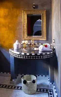 a bathroom with a sink and a mirror at Riad Touda in Marrakech