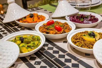 a table topped with bowls of food on a table at Riad Tchaikana in Marrakech
